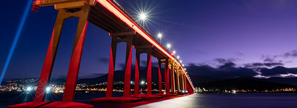 Hobart's Tasman Bridge lit up in red for Dark Mofo 2023