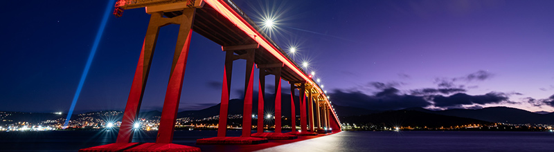 Hobart's Tasman Bridge lit up in red for Dark Mofo 2023